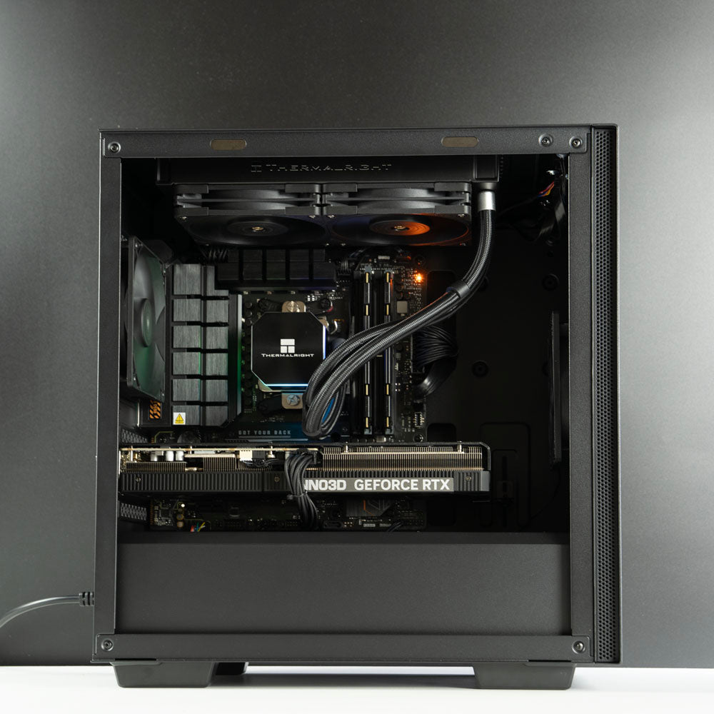 Minimalistic black AMD custom gaming PC with RGB lighting – Ryzen 7 7800X3D with NVIDIA RTX 5070 Ti 16GB, 32GB DDR5, 2TB SSD and 240mm liquid cooler in Deepcool Macube 110 case, designed for smooth 1440p and 4K gaming in Australia with a clean modern look.