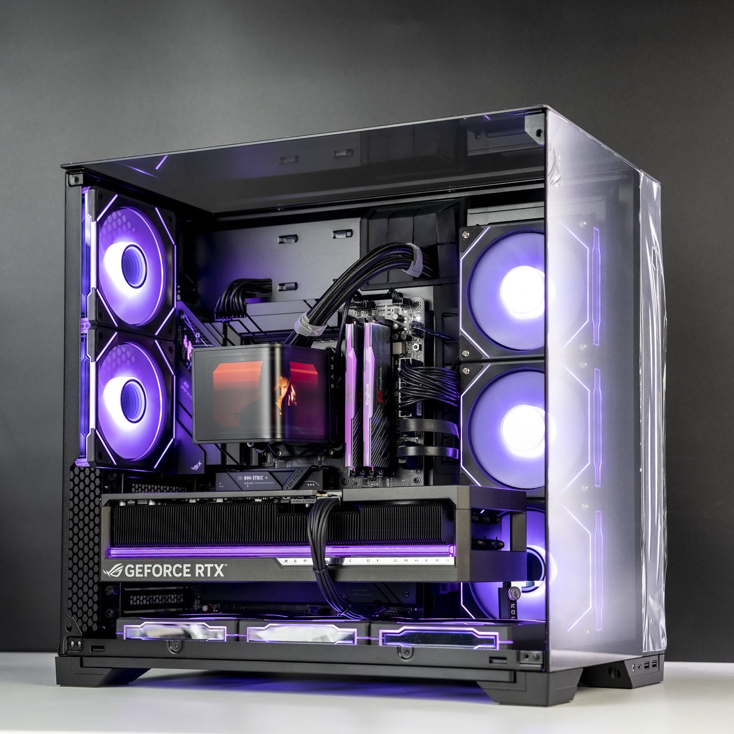 A black custom PC tower with a transparent side panel, showcasing a highly customized internal setup with glowing purple and blue LED lighting, a GeForce RTX graphics card, and dual front fans.