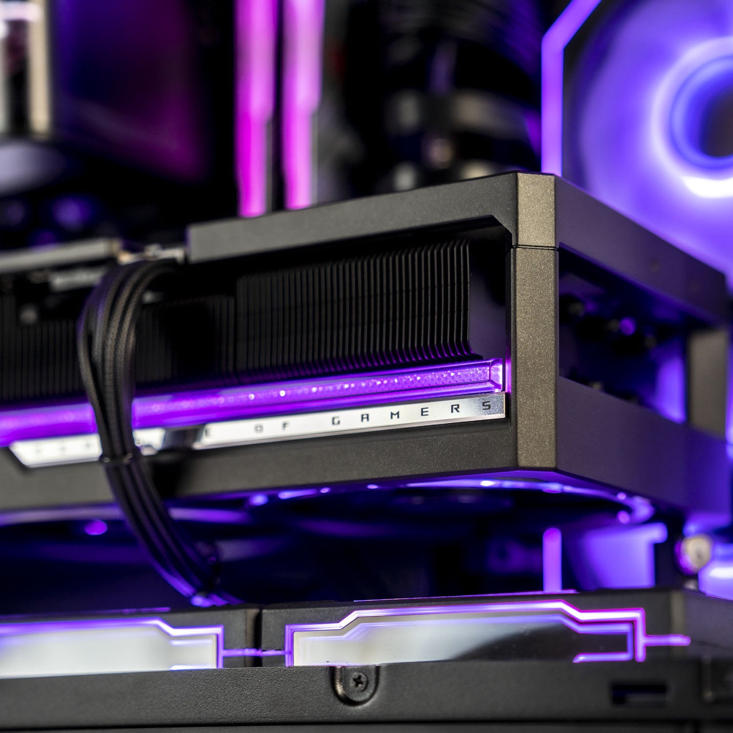 Close-up of a black gaming PC component with a purple LED light strip and a silver plate featuring the text 'Republic Of GAMERS'.